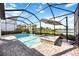 Screened pool and spa area boasts serene backyard views and an umbrella for shade at 16418 Slate Pl, Lakewood Ranch, FL 34211