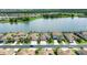 Street view of houses with solar panels on the roofs, facing a large lake on a sunny day at 17850 Polo Trl, Bradenton, FL 34211