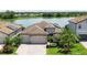 Stunning aerial view of home with water view, solar panels, and lush landscaping at 17850 Polo Trl, Bradenton, FL 34211