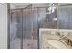 Bright bathroom featuring a glass shower stall, granite counter and sink at 17850 Polo Trl, Bradenton, FL 34211