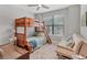 Bedroom featuring a bunk bed, futon, ceiling fan and window at 17850 Polo Trl, Bradenton, FL 34211