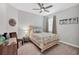 Cozy bedroom with a ceiling fan, bed, side table, art and window at 17850 Polo Trl, Bradenton, FL 34211