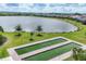 Well-maintained bocce ball courts with lush landscaping and tranquil lake views at 17850 Polo Trl, Bradenton, FL 34211