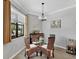 Cozy dining area with a glass table, wicker chairs, and window view at 17850 Polo Trl, Bradenton, FL 34211