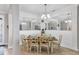 Bright dining room featuring modern chandelier, mirrors, and place settings for six at 17850 Polo Trl, Bradenton, FL 34211