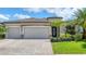 Well-maintained single-Gathering home with three-car garage, stone accents, and lush landscaping at 17850 Polo Trl, Bradenton, FL 34211