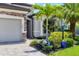 Close up of the home's stone accents, lush front yard, and brick driveway at 17850 Polo Trl, Bradenton, FL 34211