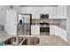 Granite countertops and stainless steel appliances accentuate this modern kitchen at 17850 Polo Trl, Bradenton, FL 34211