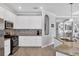 Spacious kitchen with mosaic backsplash, granite countertops, and white cabinetry at 17850 Polo Trl, Bradenton, FL 34211