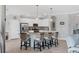 Bright kitchen with white cabinetry, granite countertops, stainless steel appliances, and island seating at 17850 Polo Trl, Bradenton, FL 34211
