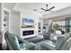 Cozy living room with fireplace, built-in shelving, and access to outdoor space with water views at 17850 Polo Trl, Bradenton, FL 34211