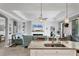 Open-concept living room with granite island, fireplace, and coastal decor at 17850 Polo Trl, Bradenton, FL 34211