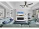 Inviting living room featuring fireplace, built-ins, ceiling fan, and comfortable seating at 17850 Polo Trl, Bradenton, FL 34211