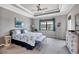 Main bedroom with tray ceiling, dresser, and tranquil water view at 17850 Polo Trl, Bradenton, FL 34211