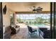 Spacious screened patio with a view of the pool and the lake beyond from its ample seating area at 17850 Polo Trl, Bradenton, FL 34211