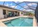 Screened pool area with a stone deck, grill, seating area, and a clear view of the blue sky and clouds at 17850 Polo Trl, Bradenton, FL 34211