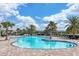 Inviting community swimming pool with ample lounge chairs for relaxing by the water at 17850 Polo Trl, Bradenton, FL 34211
