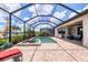 Outdoor pool area, featuring a spa, patio, lake views, and a barbecue at 17850 Polo Trl, Bradenton, FL 34211