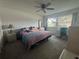Cozy bedroom featuring a comfortable bed, ceiling fan, and natural light from the window at 1999 Kings Hwy # 26A, Punta Gorda, FL 33980