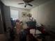 Bedroom filled with boxes, furniture, and personal items; fair natural light from a window with blinds at 1999 Kings Hwy # 26A, Punta Gorda, FL 33980