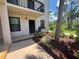 Welcoming condo entrance with a cozy chair, decorative plants, and a well-maintained exterior at 1999 Kings Hwy # 26A, Punta Gorda, FL 33980