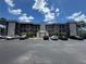 Multi-story condo building featuring a well-maintained parking lot and palm trees against a clear blue sky at 1999 Kings Hwy # 26A, Punta Gorda, FL 33980