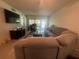 Bright living room with sectional sofa, and sliding glass doors leading to the outside at 1999 Kings Hwy # 26A, Punta Gorda, FL 33980