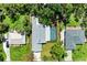 Aerial view of a property with a rectangular pool, surrounded by lush greenery at 2400 Lake Shore Dr, Nokomis, FL 34275