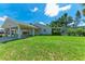 Spacious backyard featuring a well-maintained lawn and ample space for outdoor activities at 2400 Lake Shore Dr, Nokomis, FL 34275