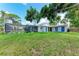 Expansive backyard featuring a screened-in pool and lush greenery at 2400 Lake Shore Dr, Nokomis, FL 34275