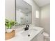 Modern bathroom features a black faucet, white marble countertop, and a sleek framed mirror at 2400 Lake Shore Dr, Nokomis, FL 34275