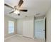 Bright bedroom with sleek tile flooring, closet, and ceiling fan at 2400 Lake Shore Dr, Nokomis, FL 34275