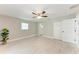 Bedroom boasts sleek tile flooring, ceiling fan, closet, and an attached bathroom at 2400 Lake Shore Dr, Nokomis, FL 34275