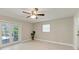 Bright bedroom with tile floors, ceiling fan, and access to the outdoor pool area at 2400 Lake Shore Dr, Nokomis, FL 34275