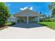 Wide carport with ample covered parking space and a view of the landscaped surroundings at 2400 Lake Shore Dr, Nokomis, FL 34275