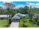 Inviting single-story home with a carport, lush greenery, and sparkling pool view at 2400 Lake Shore Dr, Nokomis, FL 34275
