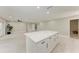 Bright, open-concept living area with a kitchen island and neutral color palette at 2400 Lake Shore Dr, Nokomis, FL 34275