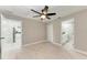 Comfortable bedroom featuring neutral paint, a ceiling fan, and easy access to ensuite bath at 2400 Lake Shore Dr, Nokomis, FL 34275