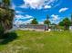 Backyard view showcasing a large grassy area and the back exterior of the home at 2416 Emory Ave, Bradenton, FL 34207