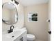 Well-lit bathroom features modern fixtures, neutral tones, and a window for natural light at 2416 Emory Ave, Bradenton, FL 34207