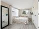 Cozy bedroom with wood style flooring, natural light, and neutral decor at 2416 Emory Ave, Bradenton, FL 34207