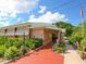 Exterior of a building featuring a walkway, landscaping and a red accent on the walkway at 2416 Emory Ave, Bradenton, FL 34207