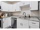 Well-lit kitchen featuring granite countertops, stainless steel appliances and white cabinets at 2416 Emory Ave, Bradenton, FL 34207