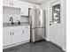 Bright kitchen with stainless steel refrigerator, granite counters, and access to the exterior at 2416 Emory Ave, Bradenton, FL 34207