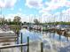 Picturesque marina view with numerous sailboats docked, their masts reflected in the calm water under a partly cloudy sky at 2416 Emory Ave, Bradenton, FL 34207