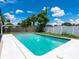 A swimming pool in a backyard with a manicured lawn, perfect for outdoor relaxation and recreation at 2416 Emory Ave, Bradenton, FL 34207