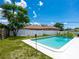 Backyard pool surrounded by lush greenery and a white fence at 2416 Emory Ave, Bradenton, FL 34207