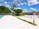 A community pool area with patio, lounge chairs, landscaping and shade umbrellas at 2416 Emory Ave, Bradenton, FL 34207