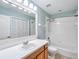 Bright bathroom with a single sink vanity, a large mirror, and a shower-tub combination at 245 Cape Harbour Loop # 103, Bradenton, FL 34212