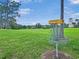 A disc golf basket in a green field with a view of a lighthouse at 245 Cape Harbour Loop # 103, Bradenton, FL 34212